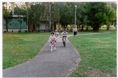 An image of people riding through a park.